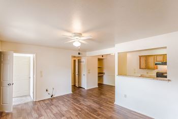 a living room with hardwood floors and a ceiling fan